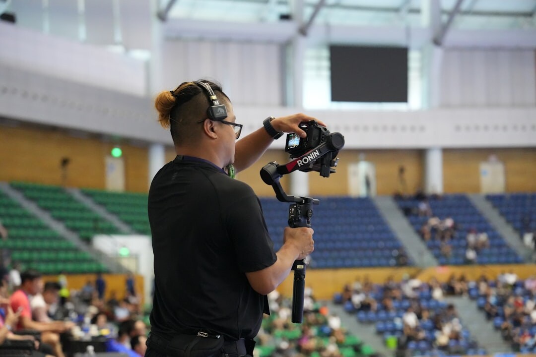 Camera crew filming a live sports event from the sideline